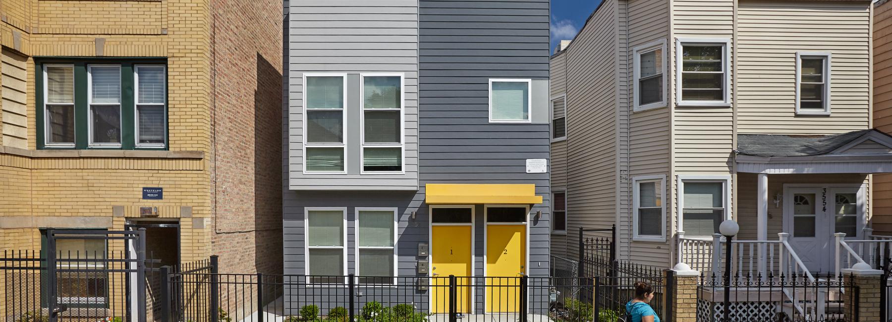 A house with a bright yellow door.